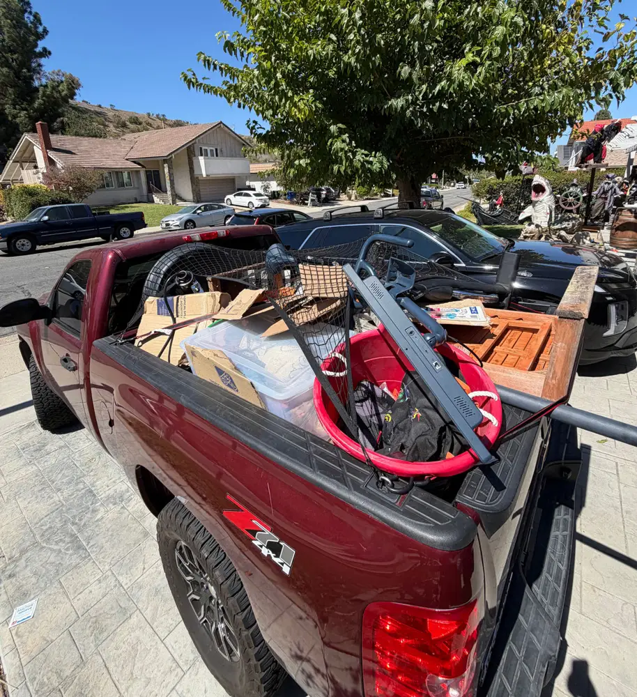 Pickup truck bed loaded with junk outside a San Diego home