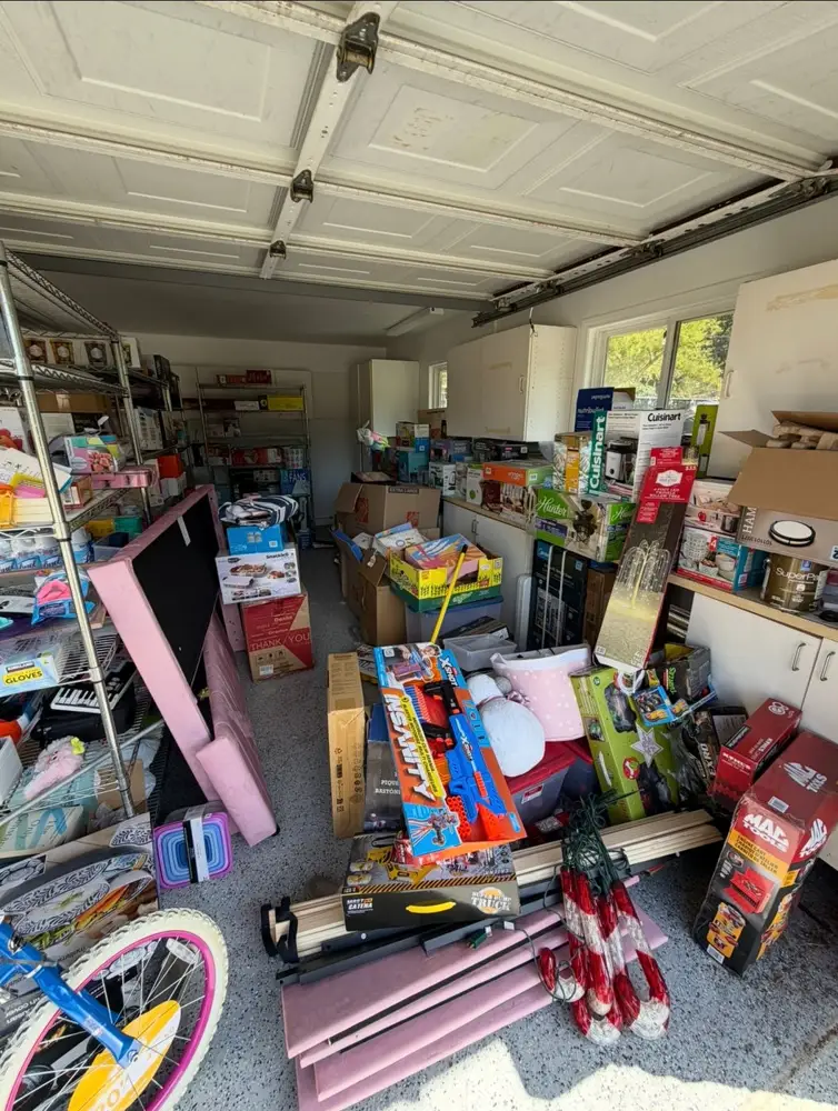 San Diego garage packed wall to wall with boxes, toys and clutter before cleanout